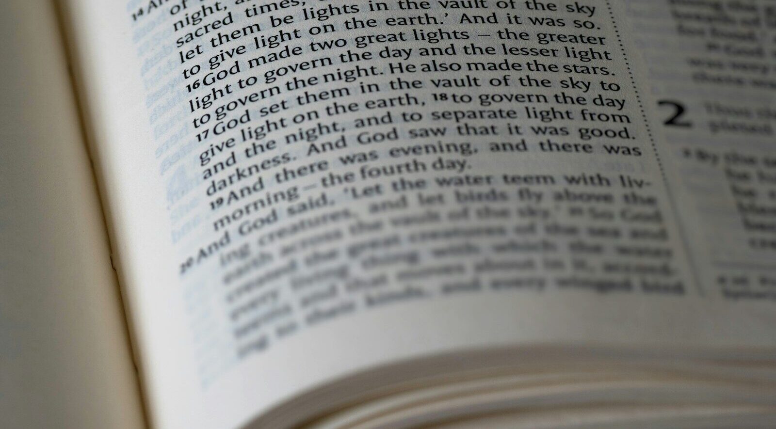 A bible is open to a passage of text.