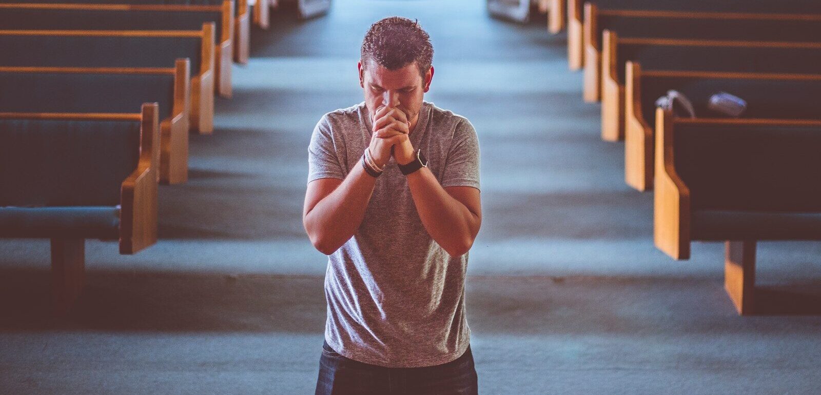 man standing near altar praying