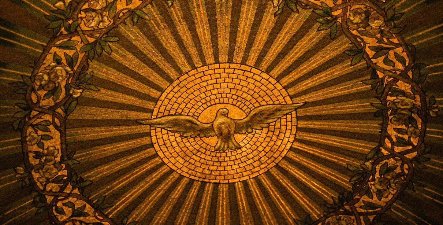 Close-up of intricate stained glass depicting the Holy Spirit in a Buffalo, NY church.