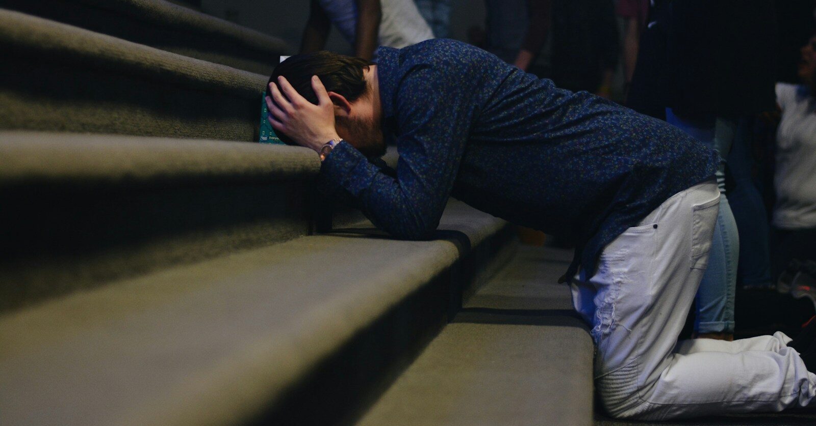 man kneeling on stair
