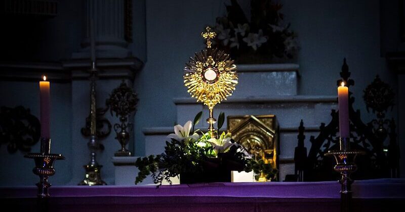 a church altar with lit candles in front of it