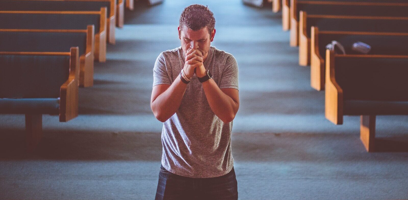 man standing near altar praying