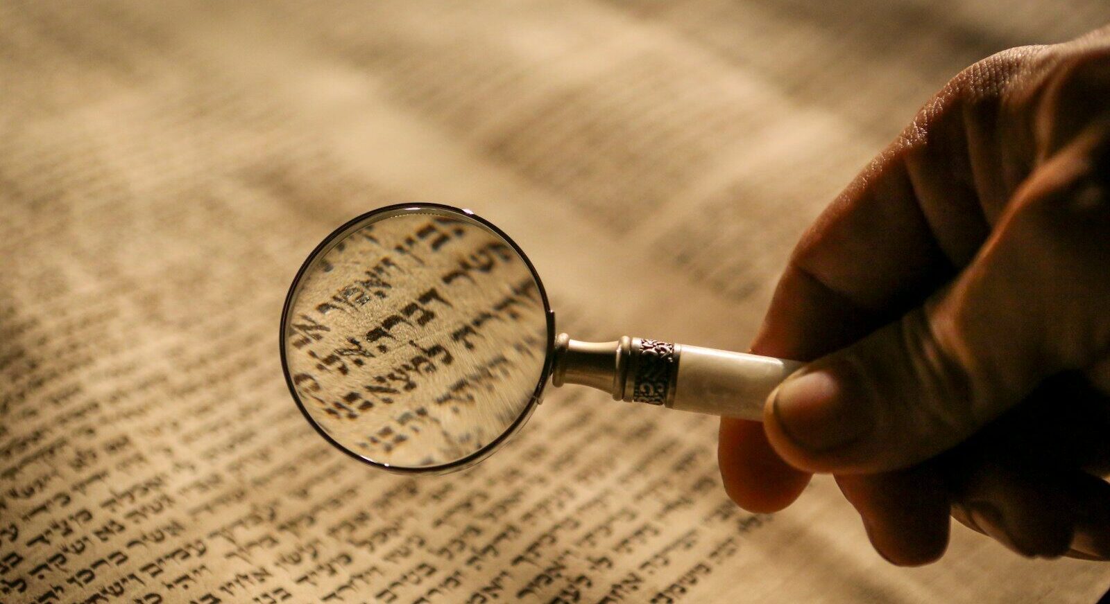 person holding magnifying glass