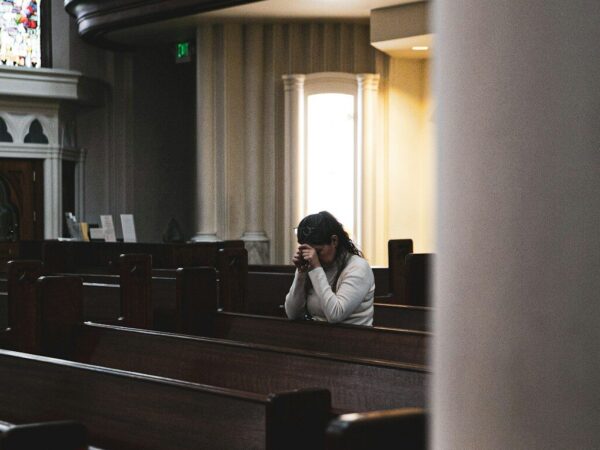 woman praying in cathedral