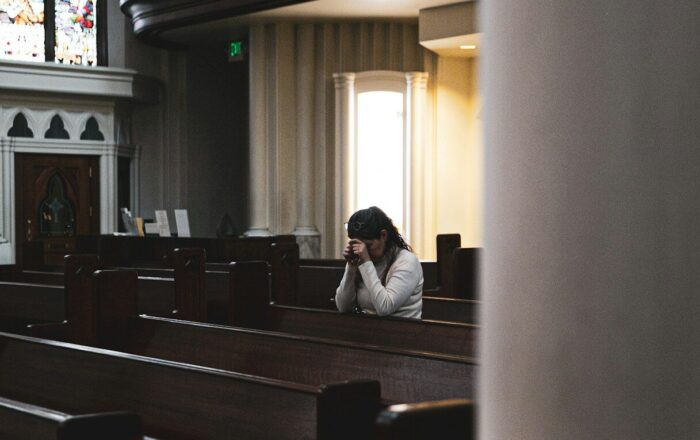 woman praying in cathedral