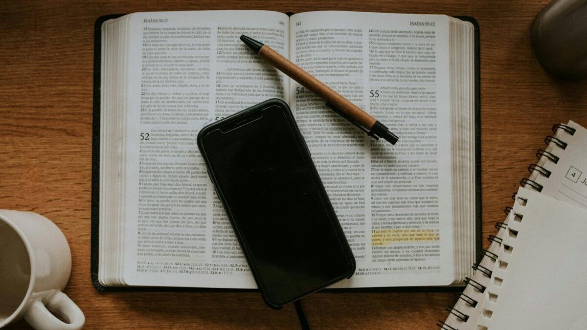 black smartphone on white notebook