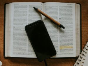black smartphone on white notebook