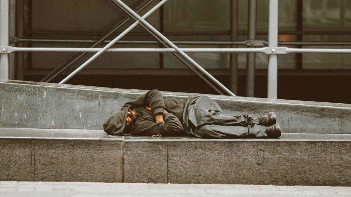 man lying on concrete stairs