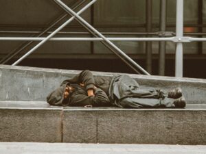 man lying on concrete stairs