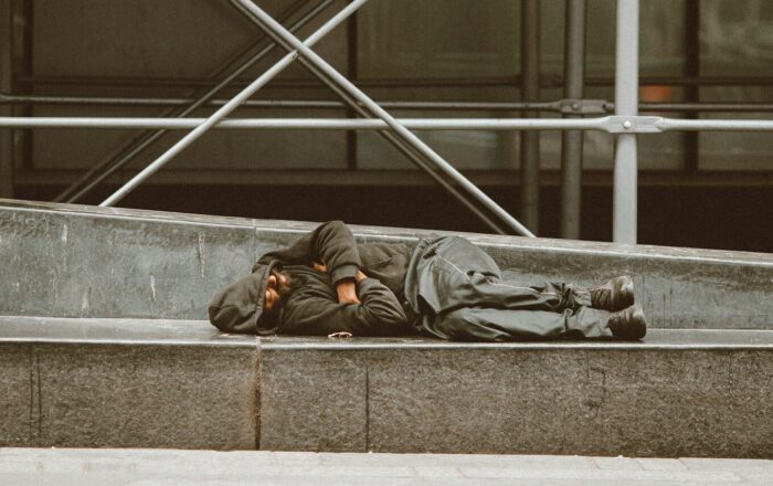 man lying on concrete stairs