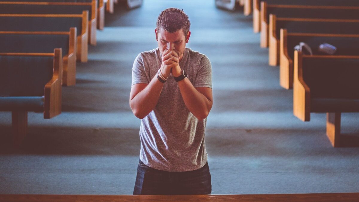man standing near altar praying