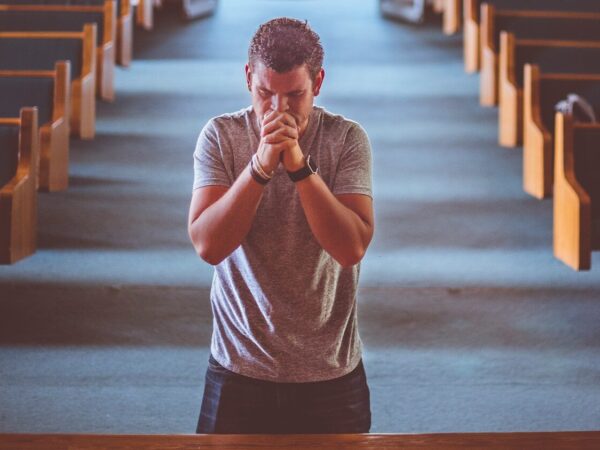 man standing near altar praying
