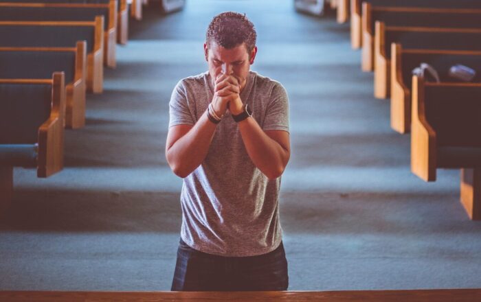 man standing near altar praying