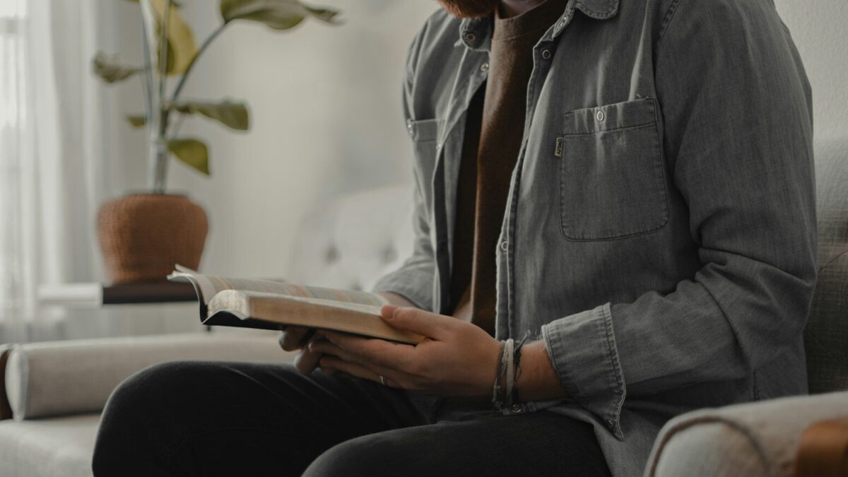 woman in blue denim jacket and black pants sitting on couch