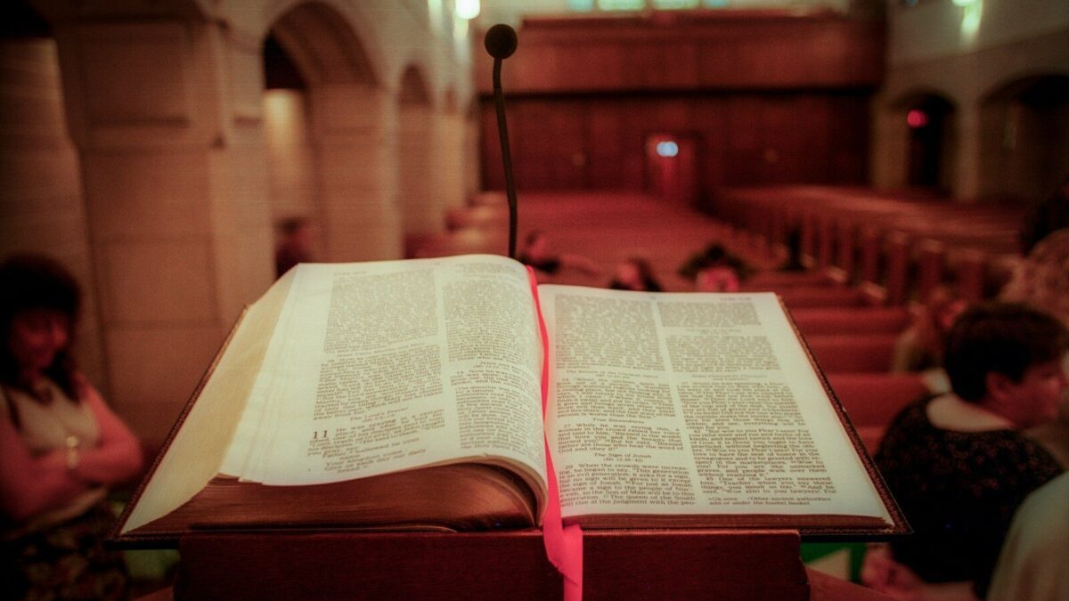 opened book on brown wooden table