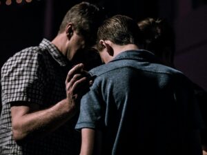 men touching each other's foreheads
