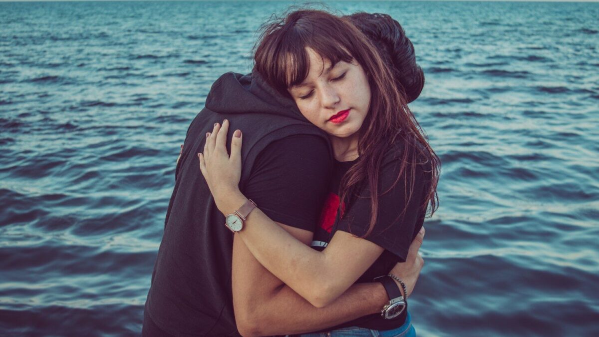 man and woman hugging
