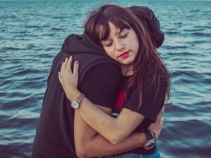 man and woman hugging
