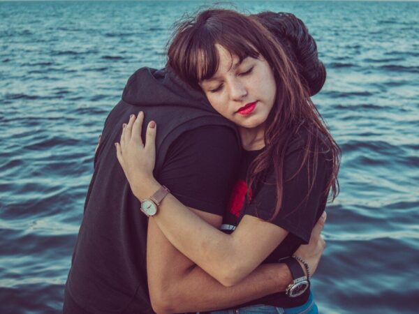 man and woman hugging