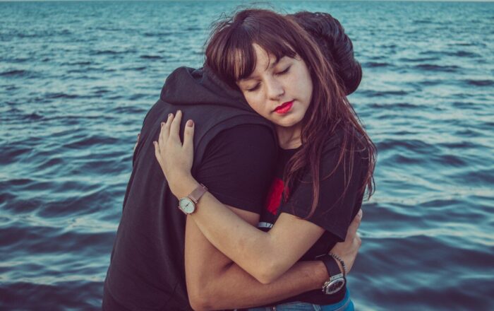 man and woman hugging