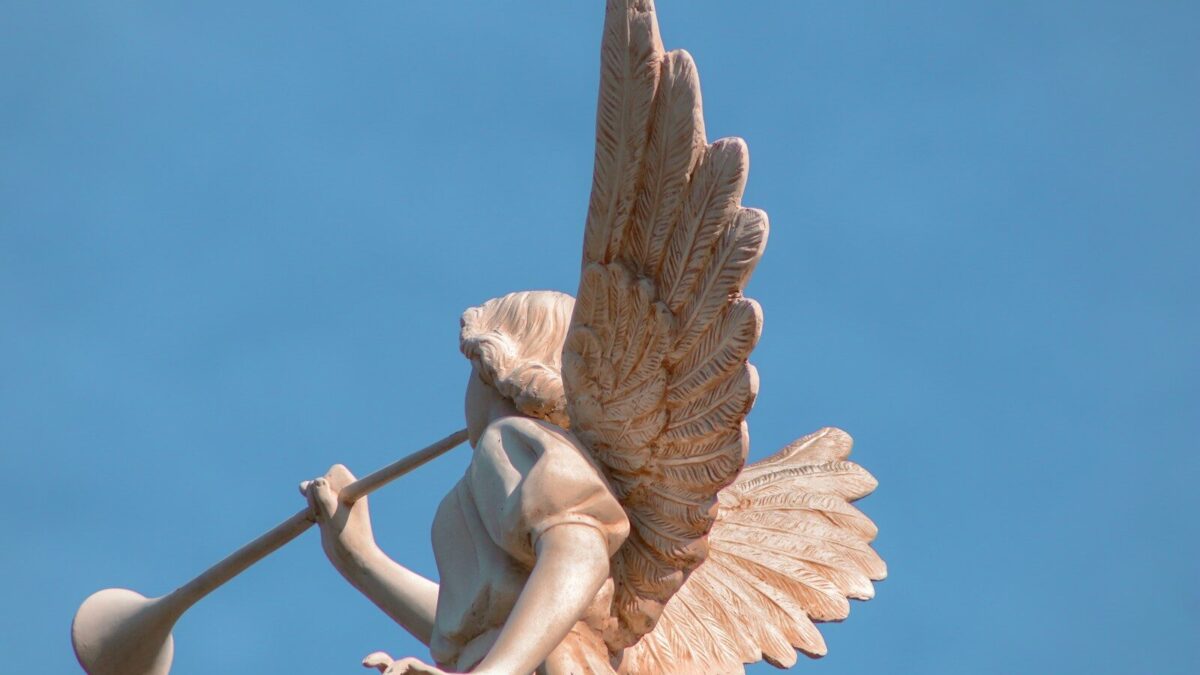 a statue of an angel holding a baseball bat